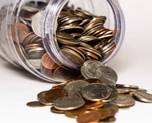 coins falling from a jar