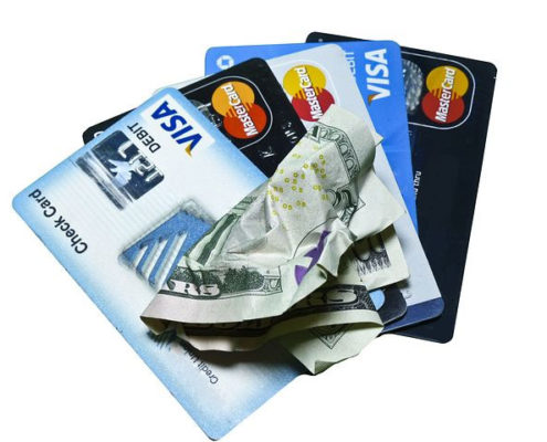 credit cards and crumpled cash