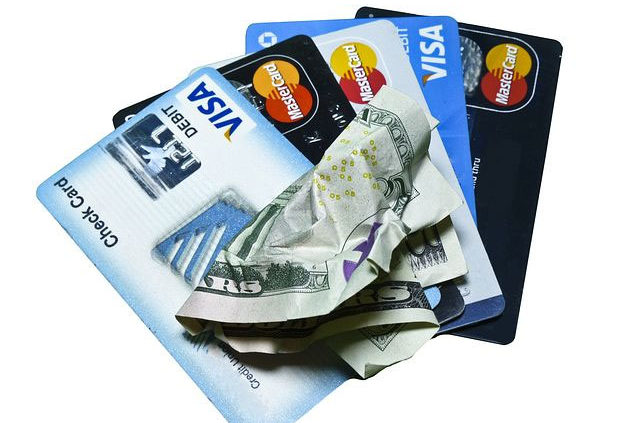 credit cards and crumpled cash