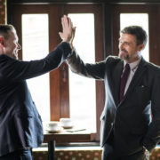 men in business suites high-fiving