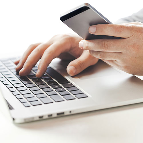 contact-us person working towards debt relief on a laptop and smartphone