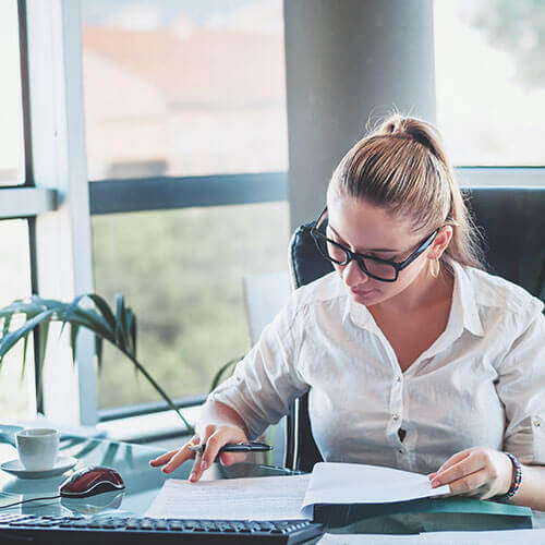 woman looking over a debt management plan at her desk