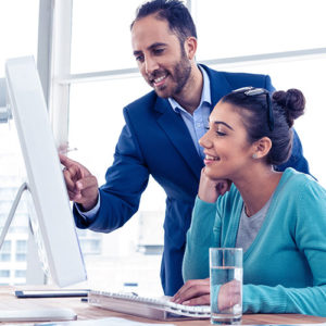 woman and man working on debt consolidation at a computer