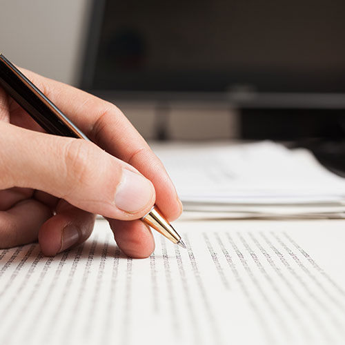 student with loan debt writing with pen in a book