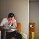stressed man sitting at his laptop