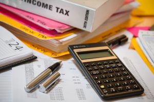 income tax book, calculator, and tax documents