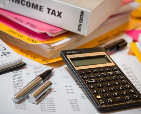 income tax book, calculator, and tax documents