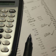 calculator sitting on paperwork for bills