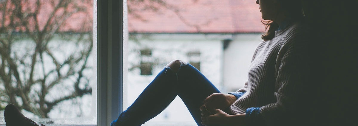 woman sitting in a window