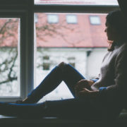 woman sitting in a window